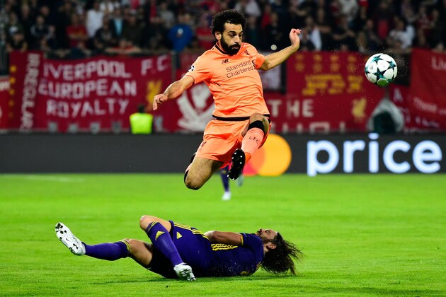 Liverpool's Egyptian forward Mohamed Salah (C up)jumps over Maribor's Slovenian defender Marko Suler (C down) during the UEFA Champions League group E football match between NK Maribor and Liverpool at the Ljudski vrt Stadium, in Maribor, on October 17, 2017. / AFP PHOTO / Jure Makovec        (Photo credit should read JURE MAKOVEC/AFP/Getty Images)