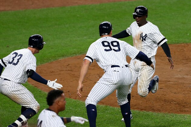 NEW YORK, NY - OCTOBER 17:  Aaron Judge #99 and Didi Gregorius #18 of the New York Yankees celebrate after scoring on a two-run go-ahead double by Gary Sanchez #24 during the eighth inning against the Houston Astros in Game Four of the American League Championship Series at Yankee Stadium on October 17, 2017 in the Bronx borough of New York City.  (Photo by Mike Stobe/Getty Images)