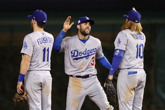 CHICAGO, IL - OCTOBER 17:  Logan Forsythe #11, Chris Taylor #3, and Justin Turner #10 of the Los Angeles Dodgers celebrate after beating the Chicago Cubs 6-1 during game three of the National League Championship Series at Wrigley Field on October 17, 2017 in Chicago, Illinois.  (Photo by Jonathan Daniel/Getty Images)