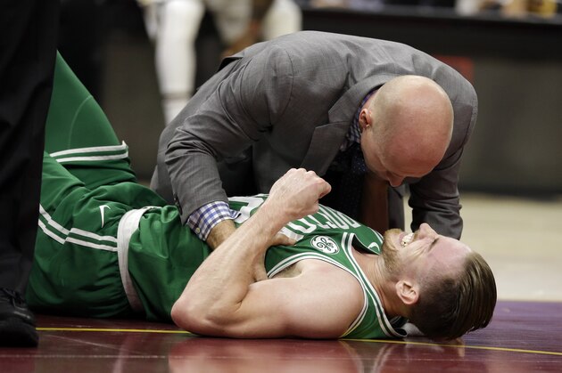 Boston Celtics' Gordon Hayward grimaces in pain in the first half of an NBA basketball game against the Cleveland Cavaliers, Tuesday, Oct. 17, 2017, in Cleveland. Just five minutes into his Boston career, new Celtics star forward Gordon Hayward gruesomely broke his left ankle, an injury that may end his season. (AP Photo/Tony Dejak)