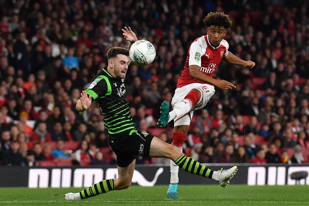 Arsenal's English midfielder Reiss Nelson (R) has an unsuccessful shot during the English League Cup third round football match between Arsenal and Doncaster Rovers at The Emirates Stadium in London on September 20, 2017. / AFP PHOTO / Ben STANSALL / RESTRICTED TO EDITORIAL USE. No use with unauthorized audio, video, data, fixture lists, club/league logos or 'live' services. Online in-match use limited to 75 images, no video emulation. No use in betting, games or single club/league/player publications.  /         (Photo credit should read BEN STANSALL/AFP/Getty Images)