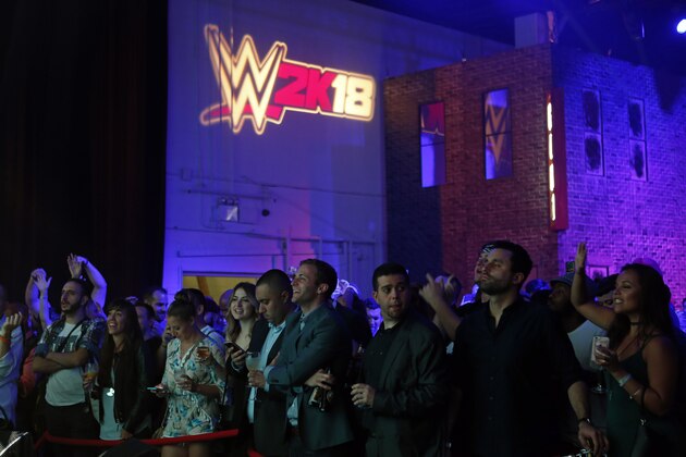 Attendees look on at the WWE 2K18 SummerSlam Kickoff Event on Friday, Aug. 18, 2017, in New York. (Photo by Adam Hunger/Invision for 2K Games/AP Images)