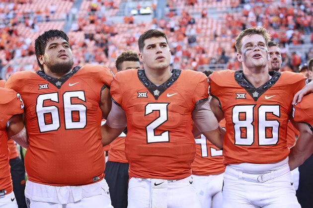 STILLWATER, OK - OCTOBER 14: Quarterback Mason Rudolph #2 sings the school song with offensive lineman Lemaefe Galea'i #66 and defensive tackle Baron Odom #86 of the Oklahoma State Cowboys after the game against the Baylor Bears at Boone Pickens Stadium on October 14, 2017 in Stillwater, Oklahoma. Oklahoma State defeated Baylor 59-16. (Photo by Brett Deering/Getty Images)
