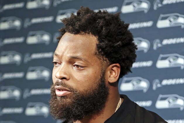 FILE - In this Sept. 24, 2017, file photo, Seattle Seahawks defensive end Michael Bennett speaks at a news conference after an NFL football game against the Tennessee Titans in Nashville, Tenn. Clark County Sheriff Joe Lombardo said Friday, Sept. 29,2017, that officers acted appropriately and professionally detaining Bennett after a report of gunfire at an after-hours club on the Las Vegas Strip.  (AP Photo/James Kenney, File)