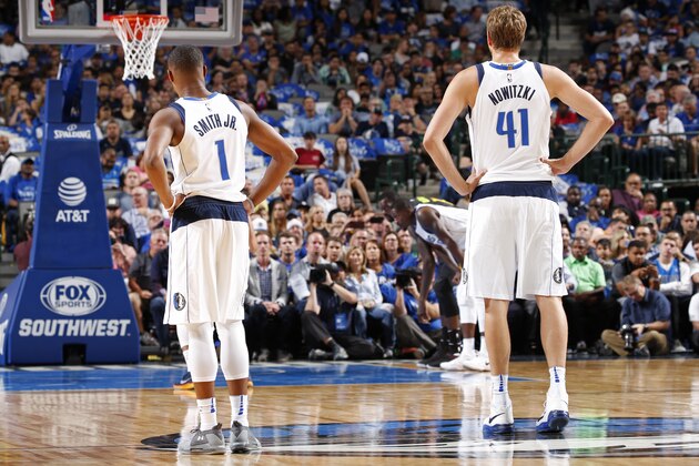 DALLAS, TX - OCTOBER 18:  Dennis Smith Jr. #1 and Dirk Nowitzki #41 of the Dallas Mavericks stand on the court during the game against the Atlanta Hawks at the American Airlines Center in Dallas, Texas on October 18, 2017. NOTE TO USER: User expressly acknowledges and agrees that, by downloading and/or using this photograph, user is consenting to the terms and conditions of the Getty Images License Agreement. Mandatory Copyright Notice: Copyright 2017 NBAE (Photo by Glenn James/NBAE via Getty Images)