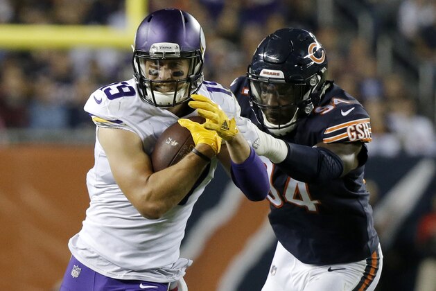 CHICAGO, IL - OCTOBER 09:   Adam Thielen #19 of the Minnesota Vikings carries the football against  Leonard Floyd #94 of the Chicago Bears in the third quarter at Soldier Field on October 9, 2017 in Chicago, Illinois.  (Photo by Jon Durr/Getty Images)