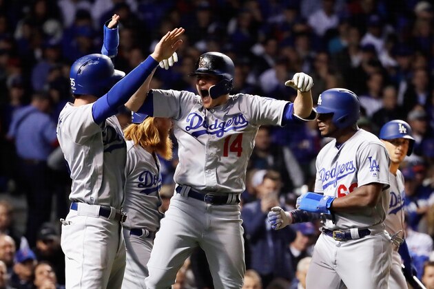 CHICAGO, IL - OCTOBER 19:  Enrique Hernandez #14 of the Los Angeles Dodgers celebrates with teammates after hitting a grand slam in the third inning against the Chicago Cubs during game five of the National League Championship Series at Wrigley Field on October 19, 2017 in Chicago, Illinois.  (Photo by Jamie Squire/Getty Images)