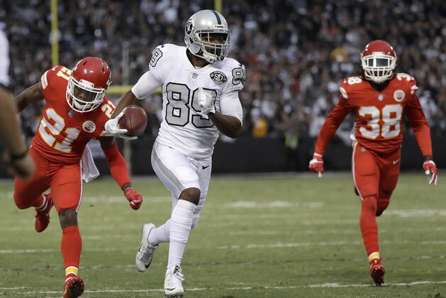 Oakland Raiders wide receiver Amari Cooper (89) runs past Kansas City Chiefs cornerback Eric Murray (21) and defensive back Ron Parker (38) to score a touchdown during the first half of an NFL football game in Oakland, Calif., Thursday, Oct. 19, 2017. (AP Photo/Marcio Jose Sanchez)
