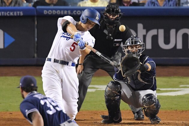 Los Angeles Dodgers' Corey Seager hits a solo home run while San Diego Padres relief pitcher Kirby Yates, left, and catcher Austin Hedges, right, watch along with home plate umpire Will Little during the sixth inning of a baseball game, Wednesday, Sept. 27, 2017, in Los Angeles. (AP Photo/Mark J. Terrill)