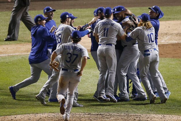 The Los Angeles Dodgers players celebrate after Game 5 of baseball's National League Championship Series against the Chicago Cubs, Thursday, Oct. 19, 2017, in Chicago. The Dodgers won 11-1 to win the series and advance to the World Series. (AP Photo/Charles Rex Arbogast)