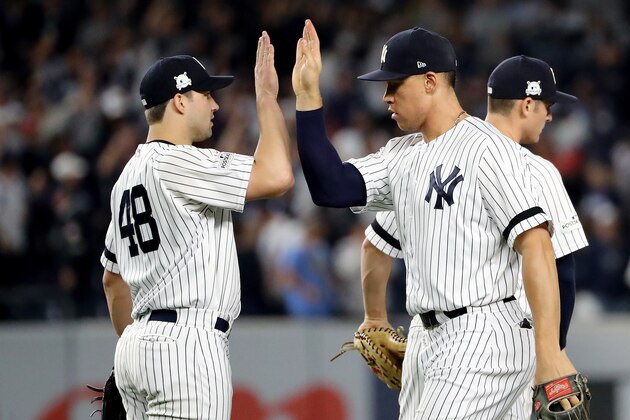 NEW YORK, NY - OCTOBER 18: Tommy Kahnle #48 and Aaron Judge #99 of the New York Yankees celebrate after defeating the Houston Astros in Game Five of the American League Championship Series at Yankee Stadium on October 18, 2017 in the Bronx borough of New York City. The New York Yankees defeated the Houston Astros 5-0. (Photo by Elsa/Getty Images)