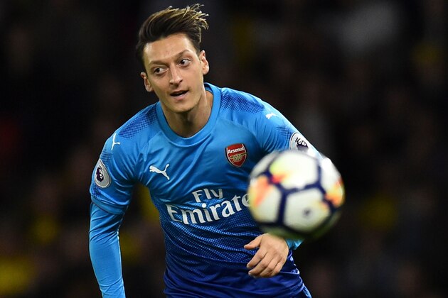 Arsenal's German midfielder Mesut Ozil chases the ball during the English Premier League football match between Watford and Arsenal at Vicarage Road Stadium in Watford, north of London on October 14, 2017. / AFP PHOTO / Glyn KIRK / RESTRICTED TO EDITORIAL USE. No use with unauthorized audio, video, data, fixture lists, club/league logos or 'live' services. Online in-match use limited to 75 images, no video emulation. No use in betting, games or single club/league/player publications.  /         (Photo credit should read GLYN KIRK/AFP/Getty Images)