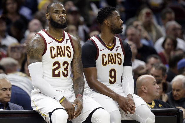 Cleveland Cavaliers' LeBron James (23) and Dwyane Wade wait to re-enter the game against the Boston Celtics in the second half of an NBA basketball game, Tuesday, Oct. 17, 2017, in Cleveland. (AP Photo/Tony Dejak)