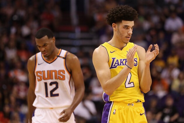 PHOENIX, AZ - OCTOBER 20:  Lonzo Ball #2 (R) of the Los Angeles Lakers applauds after a call ahead of TJ Warren #12 of the Phoenix Suns during the first half of the NBA game at Talking Stick Resort Arena on October 20, 2017 in Phoenix, Arizona.  NOTE TO USER: User expressly acknowledges and agrees that, by downloading and or using this photograph, User is consenting to the terms and conditions of the Getty Images License Agreement.  (Photo by Christian Petersen/Getty Images)