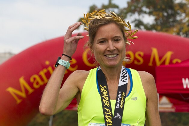 Perry Shoemaker of Vienna, Va., holds her laurel wreath after winning the 41st Marine Corps Marathon, Sunday, Oct. 30, 2016 in Arlington, Va. The race includes runners from 55 nations and each branch of the U.S. armed forces. ( AP Photo/Jose Luis Magana)
