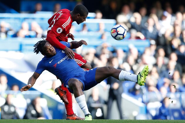 Watford's Zairean defender Christian Kabasele vies with Chelsea's Belgian striker Michy Batshuayi during the English Premier League football match between Chelsea and Watford at Stamford Bridge in London on October 21, 2017. / AFP PHOTO / Ian KINGTON / RESTRICTED TO EDITORIAL USE. No use with unauthorized audio, video, data, fixture lists, club/league logos or 'live' services. Online in-match use limited to 75 images, no video emulation. No use in betting, games or single club/league/player publications.  /         (Photo credit should read IAN KINGTON/AFP/Getty Images)