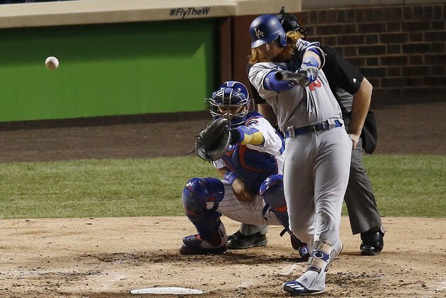 Los Angeles Dodgers' Justin Turner (10) hits a n RBI single during the third inning of Game 5 of baseball's National League Championship Series against the Chicago Cubs, Thursday, Oct. 19, 2017, in Chicago. (AP Photo/Charles Rex Arbogast)
