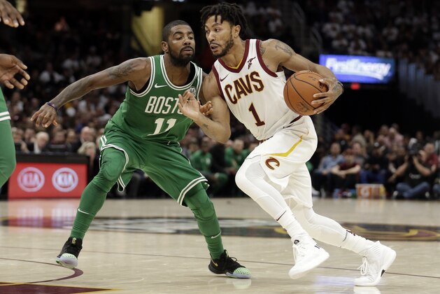 Cleveland Cavaliers' Derrick Rose (1) drives past Boston Celtics' Kyrie Irving (11) in the second half of an NBA basketball game, Tuesday, Oct. 17, 2017, in Cleveland. The Cavaliers won 102-99. (AP Photo/Tony Dejak)