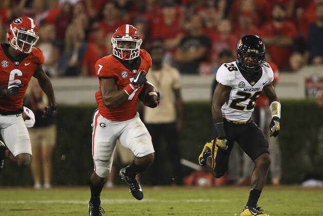 Georgia running back D'Andre Swift (7) runs as Missouri defensive back Logan Cheadle (28) gives chase in the second half of an NCAA college football game Saturday, Oct. 14, 2017, in Athens,Ga. Georgia won 53-28. (AP Photo/John Bazemore)