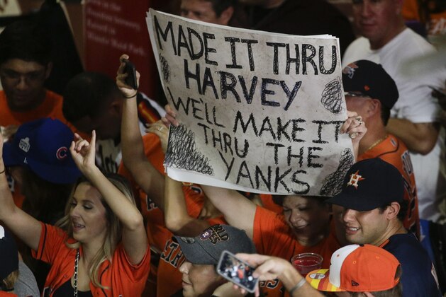 Fans celebrate after Game 7 of baseball's American League Championship Series between the Houston Astros and the New York Yankees Saturday, Oct. 21, 2017, in Houston. The Astros won 4-0 to win the series. (AP Photo/Charlie Riedel)