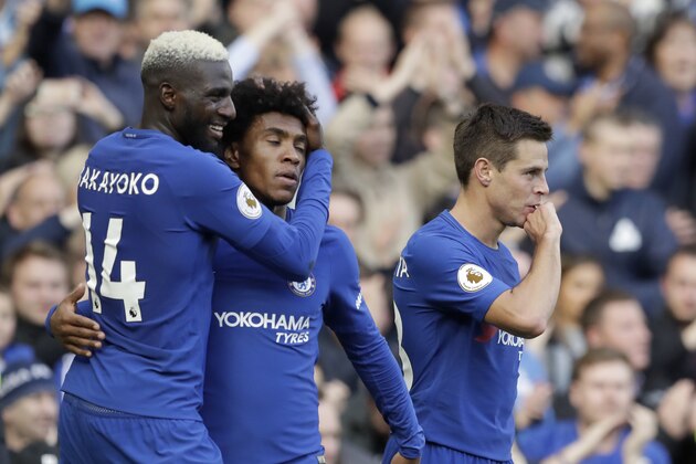 Chelsea's Cesar Azpilicueta, right, celebrates scoring his side's third goal with Tiemoue Bakayoko, left, and Chelsea's Willian during the English Premier League soccer match between Chelsea and Watford at Stamford Bridge stadium in London, Saturday, Oct. 21, 2017. (AP Photo/Matt Dunham)