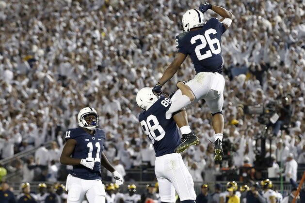 Penn State's Saquon Barkley (26) celebrates with Mike Gesicki (88) after scoring a touchdown against Michigan during the second half of an NCAA college football game in State College, Pa., Saturday, Oct. 21, 2017. Penn State won 42-13. (AP Photo/Chris Knight)