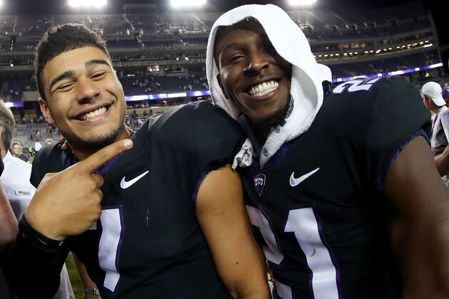 FORT WORTH, TX - OCTOBER 21:  (L-R) Kenny Hill #7 of the TCU Horned Frogs celebrates with Kyle Hicks #21 of the TCU Horned Frogs after the TCU Horned Frogs beat the Kansas Jayhawks 43-0 at Amon G. Carter Stadium on October 21, 2017 in Fort Worth, Texas.  (Photo by Tom Pennington/Getty Images)