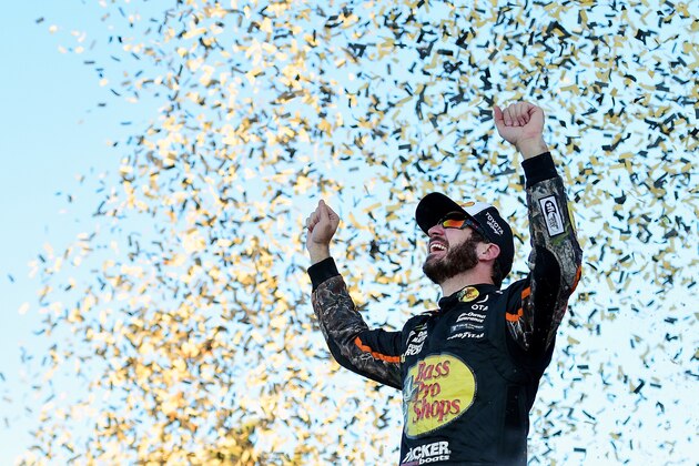 KANSAS CITY, KS - OCTOBER 22:  Martin Truex Jr., driver of the #78 Bass Pro Shops/Tracker Boats Toyota, celebrates in Victory Lane after winning the Monster Energy NASCAR Cup Series Hollywood Casino 400 at Kansas Speedway on October 22, 2017 in Kansas City, Kansas.  (Photo by Jared C. Tilton/Getty Images)
