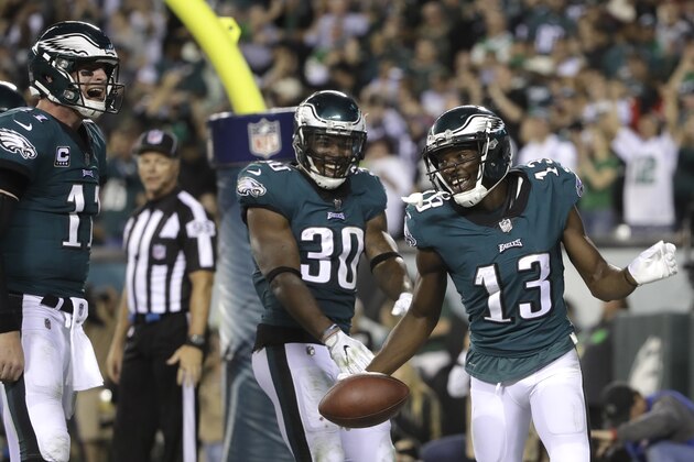 Philadelphia Eagles wide receiver Nelson Agholor (13) celebrates with Corey Clement (30) and Carson Wentz (11) after he caught a touchdown pass from Wentz during the second half of an NFL football game against the Washington Redskins, Monday, Oct. 23, 2017, in Philadelphia. (AP Photo/Matt Rourke)