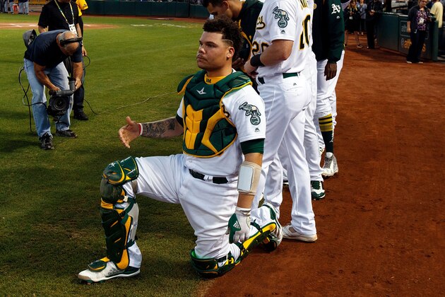 OAKLAND, CA - SEPTEMBER 25:  Bruce Maxwell #13 of the Oakland Athletics kneels during the national anthem before the game against the Seattle Mariners at the Oakland Coliseum on September 25, 2017 in Oakland, California. The Seattle Mariners defeated the Seattle Mariners 7-1. (Photo by Jason O. Watson/Getty Images)