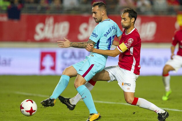 Barcelona's Paco Alcacer, left, vies for the ball with Murcia's Alex Ortiz during the Copa del Rey round of 16 first leg soccer match between Murcia and Barcelona at the Nueva Condomina stadium in Murcia, Tuesday, Oct. 24, 2017. Barcelona won 3-0. (AP Photo/Ferran Viros)