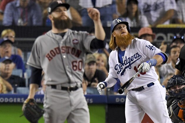 Los Angeles Dodgers' Justin Turner watches his two-run home run off Houston Astros starting pitcher Dallas Keuchel during the sixth inning of Game 1 of baseball's World Series Tuesday, Oct. 24, 2017, in Los Angeles. (AP Photo/Mark J. Terrill)