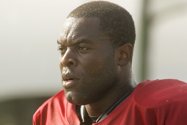 Simeon Rice walks off the practice field after a drill during Tampa Bay Buccaneers football training camp in Lake Buena Vista, Fla., Thursday, Aug. 3, 2006. (AP Photo/John Raoux)