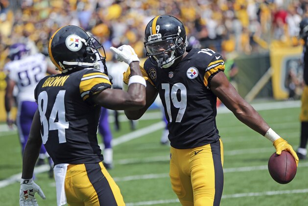 FILE - In this Sunday, Sept. 17, 2017, file photo, Pittsburgh Steelers wide receiver JuJu Smith-Schuster (19) celebrates with Antonio Brown (84) after scoring during the first half of an NFL football game against the Minnesota Vikings in Pittsburgh. The youngest player in the NFL wears SpongeBob slippers and scored the first touchdown of his career last weekend, though 20-year-old Steelers wide receiver JuJu Smith-Schuster may have turned more heads with a crunching block that showed the NFL is child's play(AP Photo/Don Wright, File)