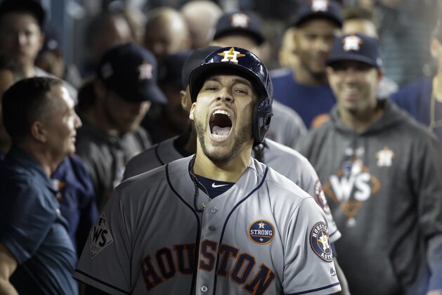 Houston Astros' George Springer celebrates after hitting a two-run home run during the 11th inning of Game 2 of baseball's World Series against the Los Angeles Dodgers Wednesday, Oct. 25, 2017, in Los Angeles. (AP Photo/David J. Phillip)