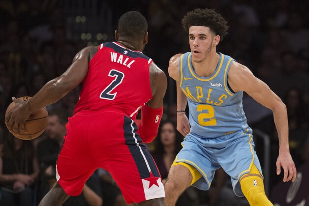 Los Angeles Lakers guard Lonzo Ball, right, defends Washington Wizards guard John Wall during the second half of an NBA basketball game in Los Angeles, Wednesday, Oct. 25, 2017. (AP Photo/Kyusung Gong)