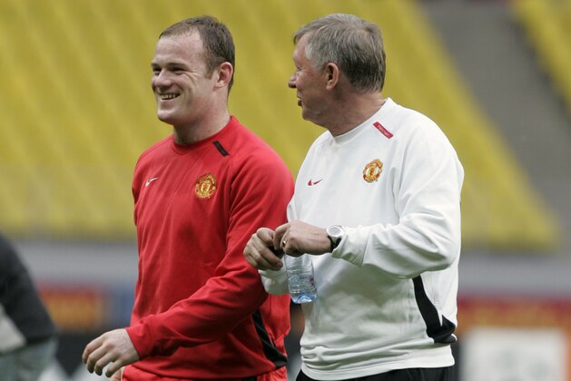 Manchester United's Wayne Rooney, left, smiles as he leaves the field with manager Alex Ferguson after a training session at the Luzhniki Stadium in Moscow, Tuesday May 20, 2008. Chelsea will face Manchester United in the first all-English Champions League final soccer match at Luzhniki Stadium in Moscow Wednesday. (AP Photo/Ivan Sekretarev)