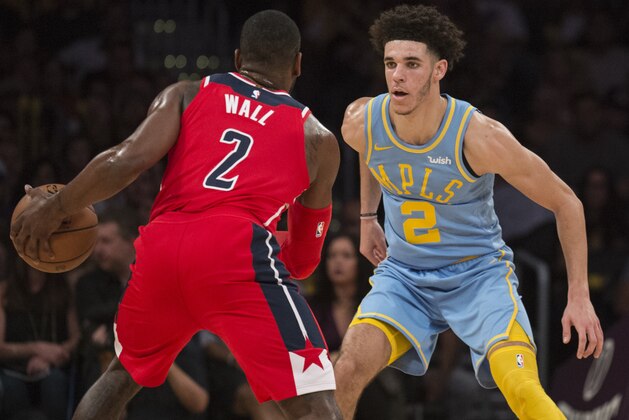 Los Angeles Lakers guard Lonzo Ball, right, defends Washington Wizards guard John Wall during the second half of an NBA basketball game in Los Angeles, Wednesday, Oct. 25, 2017. (AP Photo/Kyusung Gong)