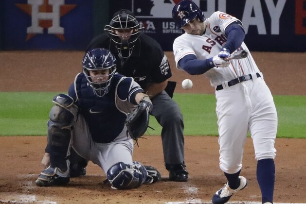 Houston Astros' George Springer hits a single during the first inning of Game 7 of baseball's American League Championship Series against the New York Yankees Saturday, Oct. 21, 2017, in Houston. (AP Photo/Charlie Riedel)