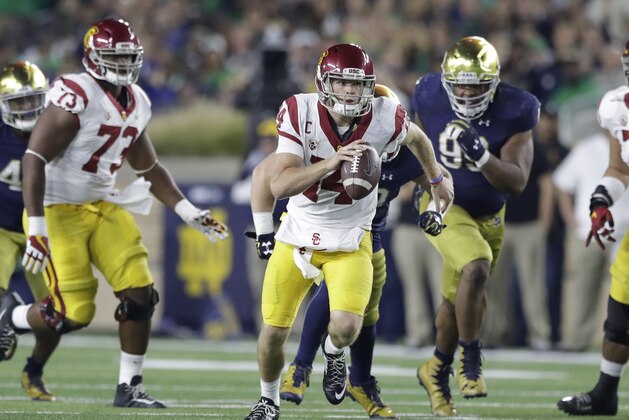 Southern California quarterback Sam Darnold scrambles during the second half of an NCAA college football game against Notre Dame, Saturday, Oct. 21, 2017, in South Bend, Ind. (AP Photo/Carlos Osorio)