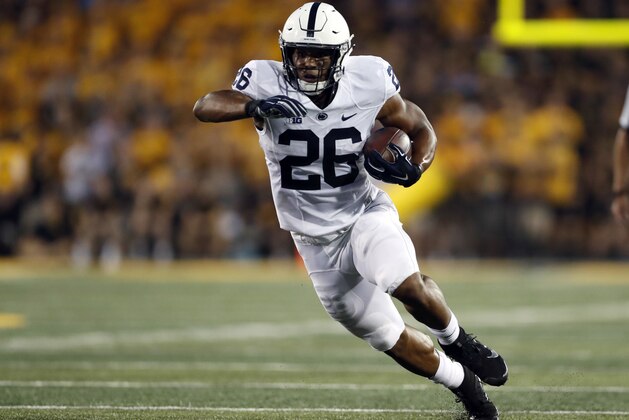 FILE - In this Saturday, Sept. 23, 2017 file photo, Penn State running back Saquon Barkley runs with the ball during the first half of an NCAA college football game against Iowa in Iowa City, Iowa. Penn State's Saquon Barkley leads all FBS players with 243.6 all-purpose yards per game and has seen his workload increase since last season. Through five games, Barkley’s scored rushing, receiving and return touchdowns and only four players have more touches than his 121, 23 more than he had at this point last season. (AP Photo/Jeff Roberson, File)
