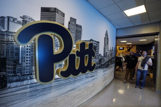People walk out of the Panther Store at the Petersen Events Center at the University of Pittsburgh before a presentation announcing the use of the classic