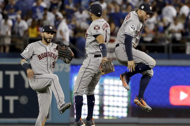 Houston Astros left fielder Marwin Gonzalez, from left, Carlos Correa and George Springer celebrate their win against the Los Angeles Dodgers during Game 2 of baseball's World Series Wednesday, Oct. 25, 2017, in Los Angeles. The Astros won 7-6 to tie the series at 1-1. (AP Photo/Matt Slocum)
