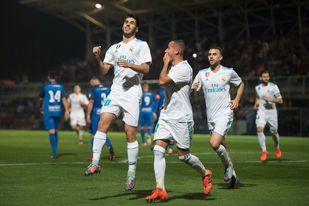 MADRID, SPAIN - OCTOBER 26: Marco Asensio of Real Madrid CF celebrates with teammates after scoring his teamÕs opening goal from a penalty kick during the Copa del Rey, Round of 32, First Leg match between Fuenlabrada and Real Madrid at Estadio Fernando Torres on October 26, 2017 in Madrid, Spain. (Photo by Denis Doyle/Getty Images)