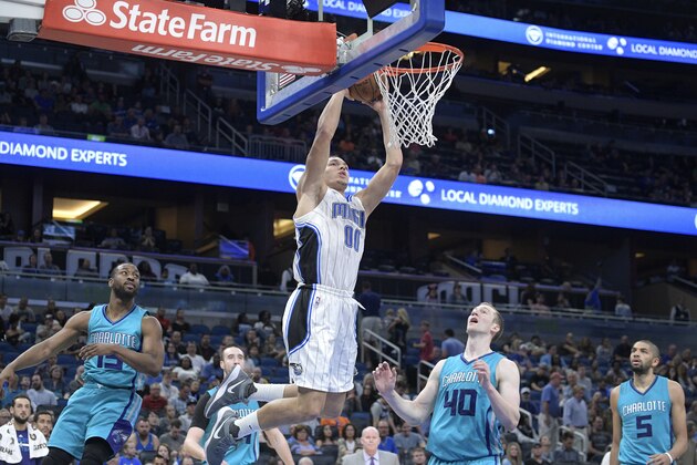 Orlando Magic forward Aaron Gordon (00) dunks the ball in front of Charlotte Hornets guard Kemba Walker (15), center Frank Kaminsky, second from left, center Frank Kaminsky and guard Nicolas Batum (5) during the second half of an NBA basketball game in Orlando, Fla., Wednesday, March 22, 2017. The Hornets won 109-102. (AP Photo/Phelan M. Ebenhack) Orlando Magic forward Aaron Gordon (00) dunks the ball in front of Charlotte Hornets guard Kemba Walker (15), center Frank Kaminsky, second from left, center Frank Kaminsky and guard Nicolas Batum (5) during the second half of an NBA basketball game in Orlando, Fla., Wednesday, March 22, 2017. The Hornets won 109-102. (AP Photo/Phelan M. Ebenhack)