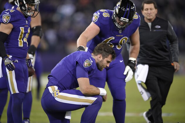 Baltimore Ravens quarterback Joe Flacco is assisted off the field after being tackled by Miami Dolphins middle linebacker Kiko Alonso in the first half of an NFL football game, Thursday, Oct. 26, 2017, in Baltimore. (AP Photo/Nick Wass)
