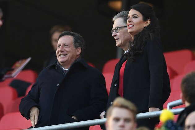 (L-R) Liverpool Chairman Tom Werner, Liverpool's US owner John W. Henry and Henry's film producer wife Linda Pizzuti take their places for the English Premier League football match between Liverpool and Sunderland at Anfield in Liverpool, north west England on November 26, 2016. / AFP / Paul ELLIS / RESTRICTED TO EDITORIAL USE. No use with unauthorized audio, video, data, fixture lists, club/league logos or 'live' services. Online in-match use limited to 75 images, no video emulation. No use in betting, games or single club/league/player publications.  /         (Photo credit should read PAUL ELLIS/AFP/Getty Images)