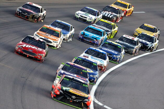 KANSAS CITY, KS - OCTOBER 22:  Martin Truex Jr., driver of the #78 Bass Pro Shops/Tracker Boats Toyota, leads a pack of cars during the Monster Energy NASCAR Cup Series Hollywood Casino 400 at Kansas Speedway on October 22, 2017 in Kansas City, Kansas.  (Photo by Jamie Squire/Getty Images)