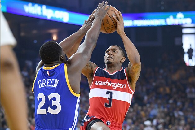 OAKLAND, CA - APRIL 02:  Bradley Beal #3 of the Washington Wizards shoots over Draymond Green #23 of the Golden State Warriors during an NBA Basketball game at ORACLE Arena on April 2, 2017 in Oakland, California. NOTE TO USER: User expressly acknowledges and agrees that, by downloading and or using this photograph, User is consenting to the terms and conditions of the Getty Images License Agreement.  (Photo by Thearon W. Henderson/Getty Images)