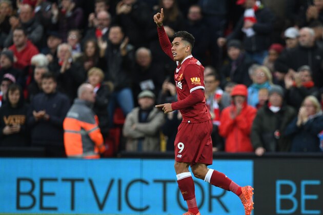 Liverpool's Brazilian midfielder Roberto Firmino celebrates after scoring their second goal with this header during the English Premier League football match between Liverpool and Huddersfield Town at Anfield in Liverpool, north west England on October 28, 2017. / AFP PHOTO / Paul ELLIS / RESTRICTED TO EDITORIAL USE. No use with unauthorized audio, video, data, fixture lists, club/league logos or 'live' services. Online in-match use limited to 75 images, no video emulation. No use in betting, games or single club/league/player publications.  /         (Photo credit should read PAUL ELLIS/AFP/Getty Images)